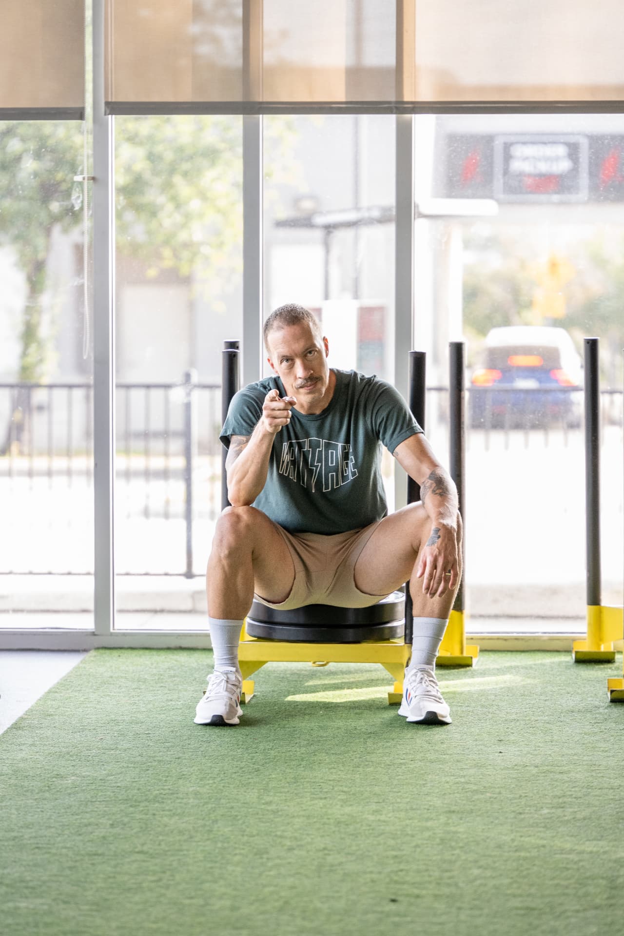 Coach pointing at the camera inside the Athletic Outcomes gym