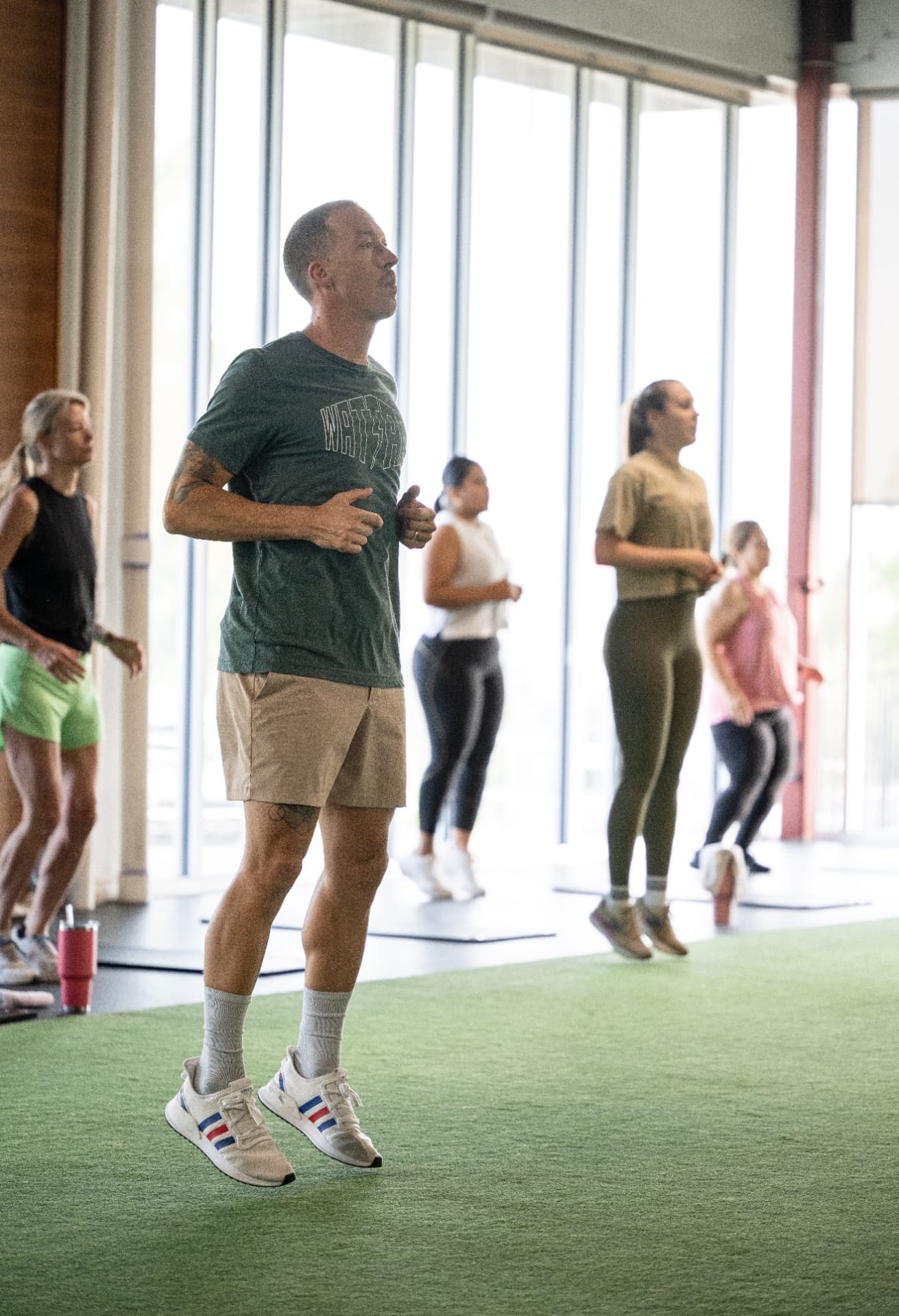 Athletes mid-bounce during a class at Athletic Outcomes